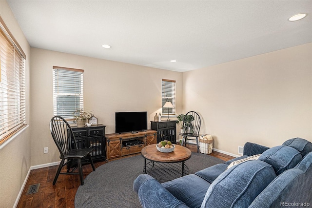 living room featuring recessed lighting, dark wood finished floors, visible vents, and baseboards