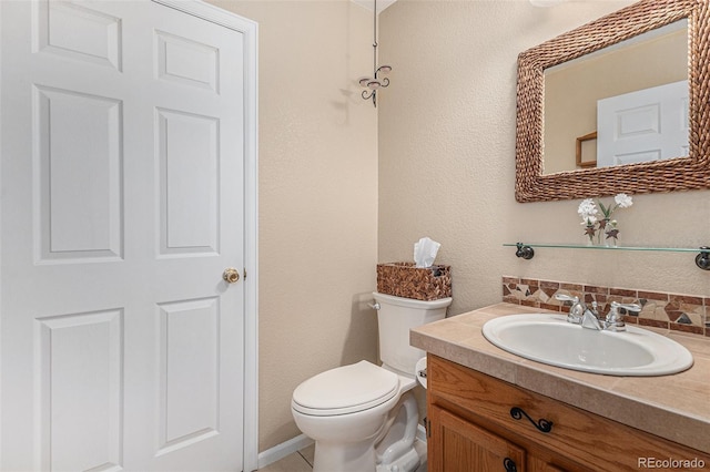 half bath with toilet, decorative backsplash, and vanity