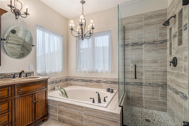 bathroom with a healthy amount of sunlight, a shower stall, and an inviting chandelier