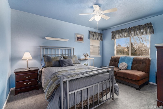 bedroom featuring a textured ceiling, carpet floors, ceiling fan, and baseboards