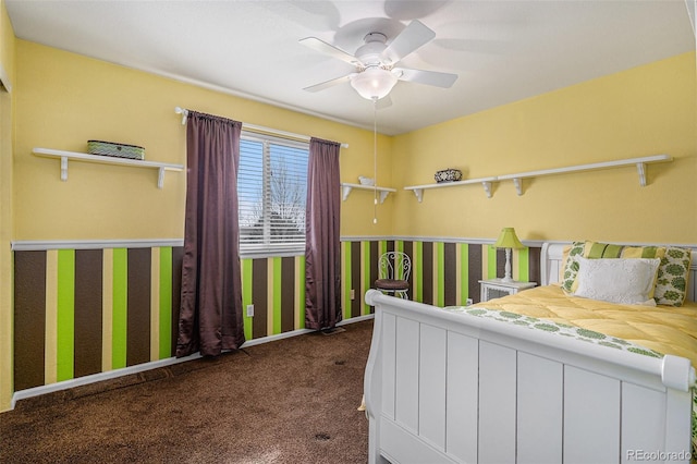 carpeted bedroom with a ceiling fan and baseboards