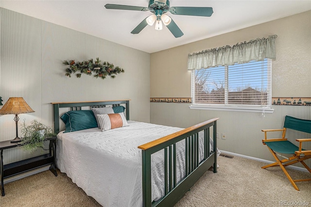 carpeted bedroom featuring visible vents and a ceiling fan