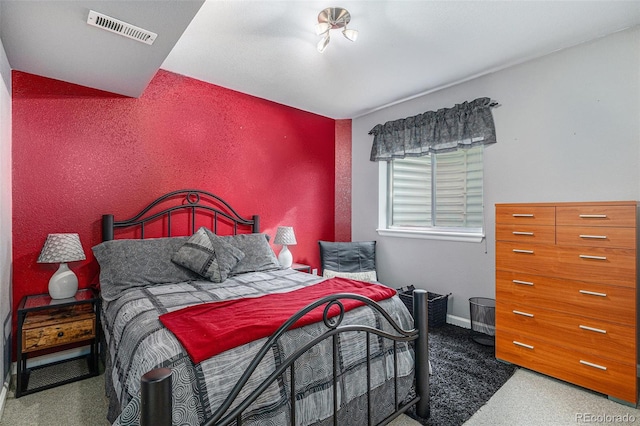 carpeted bedroom featuring visible vents and baseboards