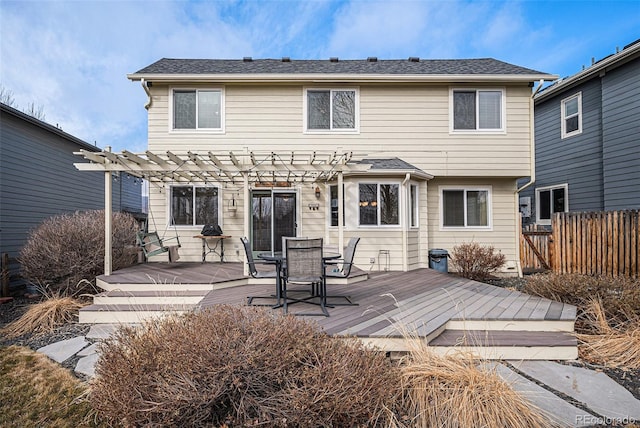 rear view of property with a deck, a shingled roof, fence, a pergola, and outdoor dining space