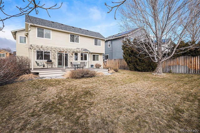 back of property featuring a patio area, a fenced backyard, a pergola, and a lawn