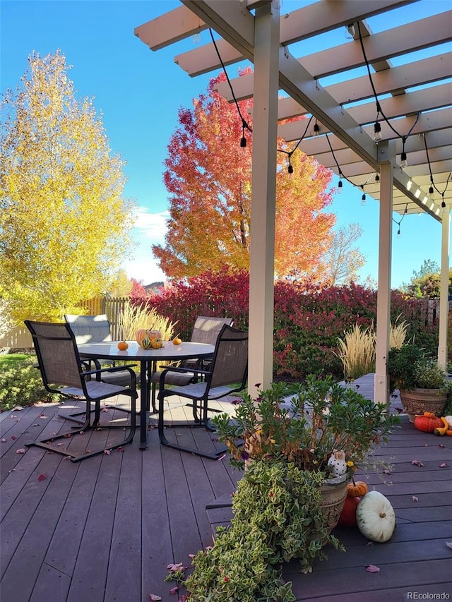 wooden deck featuring outdoor dining space and a pergola