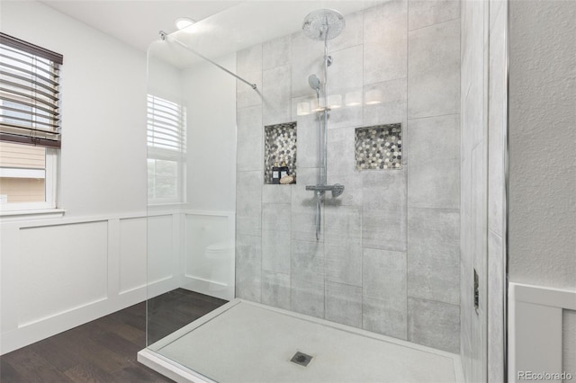 5733 S Yakima Way, Aurora, CO 80015 - bathroom featuring wood finished floors, tiled shower, and wainscoting