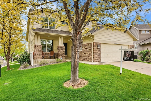 20532 E Lake Cir, Centennial, CO 80016 - view of front of property featuring brick siding, covered porch, driveway, and a front lawn