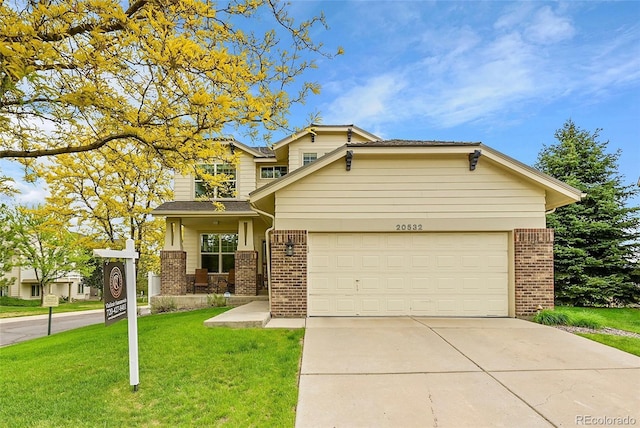 20532 E Lake Cir, Centennial, CO 80016 - view of front of house with brick siding, concrete driveway, a front yard, and an attached garage