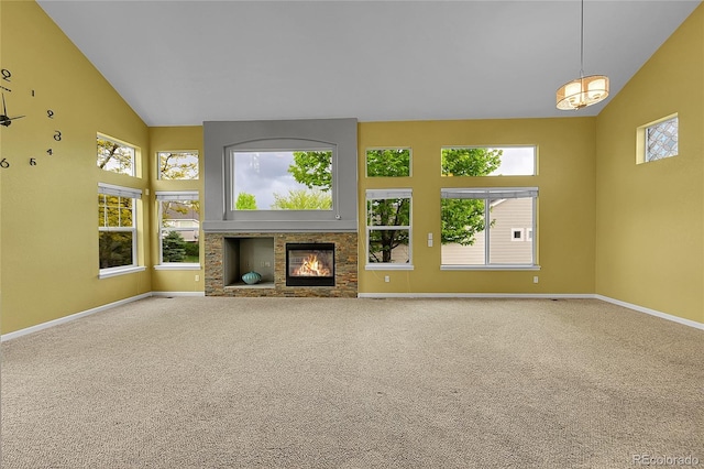 20532 E Lake Cir, Centennial, CO 80016 - unfurnished living room with high vaulted ceiling, baseboards, a glass covered fireplace, and carpet flooring