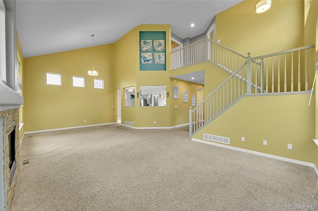 20532 E Lake Cir, Centennial, CO 80016 - unfurnished living room with high vaulted ceiling, carpet flooring, a fireplace, baseboards, and stairway