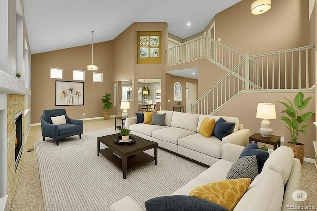 20532 E Lake Cir, Centennial, CO 80016 - carpeted living room with high vaulted ceiling, a fireplace, stairs, and baseboards