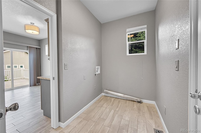 20532 E Lake Cir, Centennial, CO 80016 - laundry area with light wood-style flooring, baseboards, a textured wall, and hookup for a washing machine