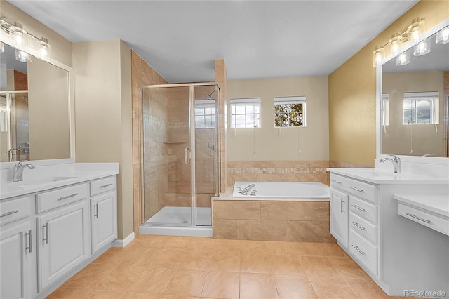 20532 E Lake Cir, Centennial, CO 80016 - bathroom featuring two vanities, tile patterned flooring, a shower stall, and a garden tub