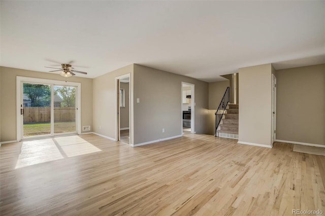 3055 Carson St, Aurora, CO 80011 - unfurnished living room featuring light wood finished floors, stairs, baseboards, and a ceiling fan