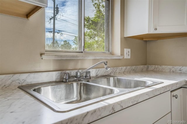 3055 Carson St, Aurora, CO 80011 - kitchen featuring a sink, white cabinets, and light countertops