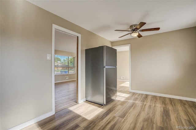 3055 Carson St, Aurora, CO 80011 - spare room with light wood-style flooring, ceiling fan, and baseboards