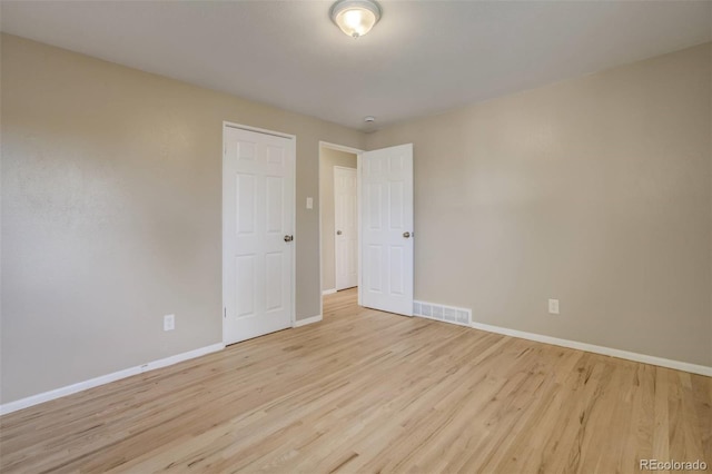 3055 Carson St, Aurora, CO 80011 - empty room with wood finished floors and baseboards