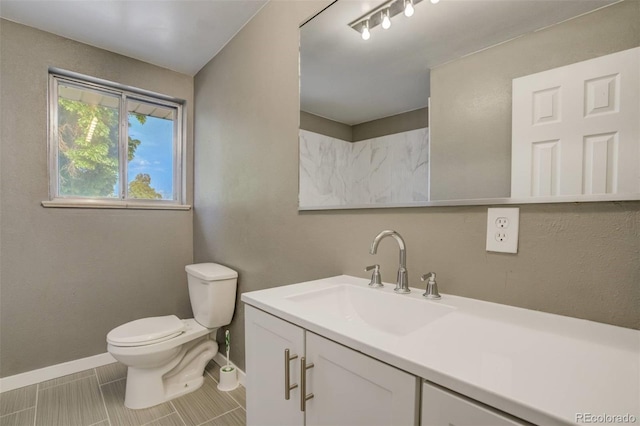 3055 Carson St, Aurora, CO 80011 - bathroom with baseboards, vanity, and toilet