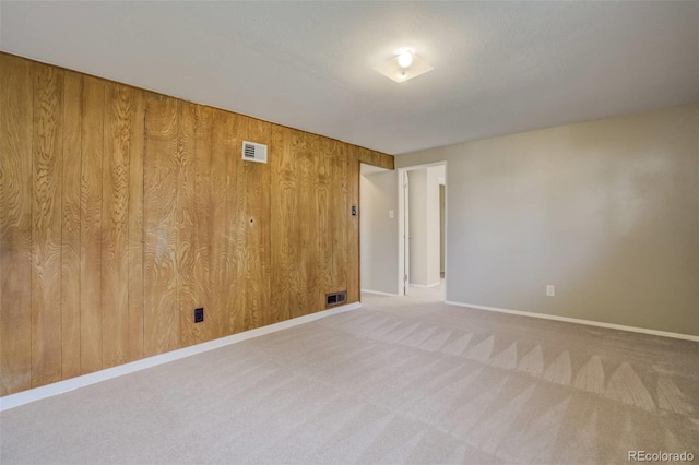 3055 Carson St, Aurora, CO 80011 - spare room with carpet flooring, baseboards, and wood walls