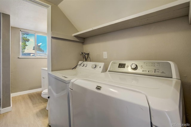 3055 Carson St, Aurora, CO 80011 - laundry area with light wood-style floors, independent washer and dryer, and baseboards