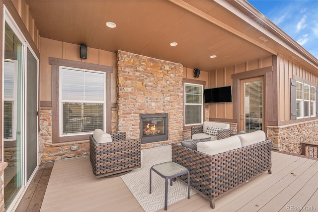 deck featuring an outdoor stone fireplace