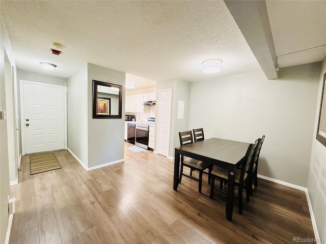 8625 Clay St Unit 228, Westminster, CO 80031 - dining room with light wood finished floors and a textured ceiling