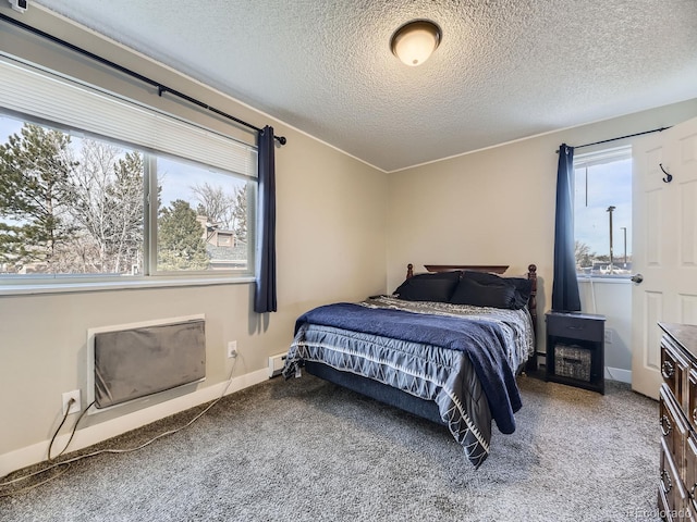 bedroom with carpet flooring, baseboard heating, and a textured ceiling