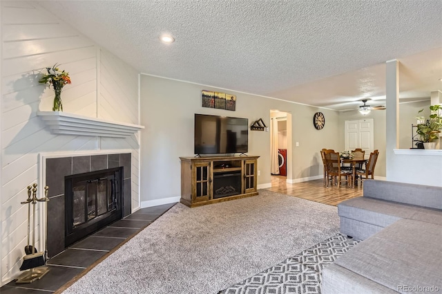2280 S Oswego Way Unit 104, Aurora, CO 80014 - carpeted living room featuring a tile fireplace, a textured ceiling, ceiling fan, and recessed lighting