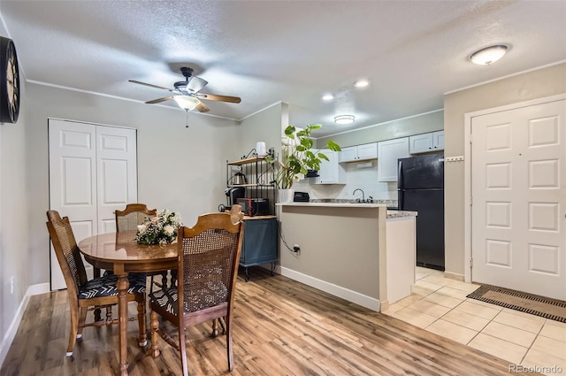 2280 S Oswego Way Unit 104, Aurora, CO 80014 - dining space featuring a ceiling fan, light wood-style floors, crown molding, a textured ceiling, and recessed lighting