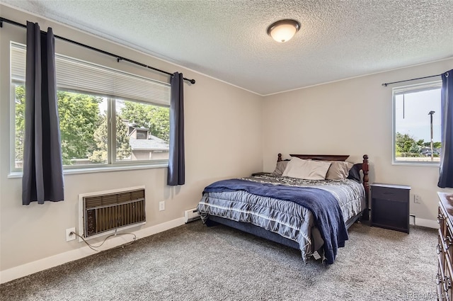 2280 S Oswego Way Unit 104, Aurora, CO 80014 - carpeted bedroom featuring a wall unit AC, a textured ceiling, and baseboard heating