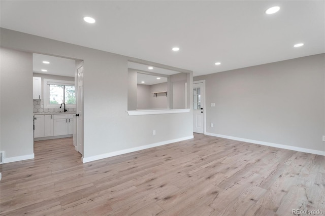 8280 Auburn Ln, Westminster, CO 80031 - unfurnished living room with light wood-style flooring and recessed lighting