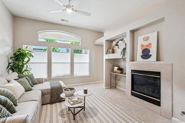 2870 W Riverwalk Cir Unit B, Littleton, CO 80123 - living area with a tiled fireplace, carpet floors, ceiling fan, and built in shelves