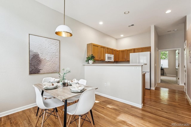 2870 W Riverwalk Cir Unit B, Littleton, CO 80123 - dining area featuring light wood-style flooring and recessed lighting