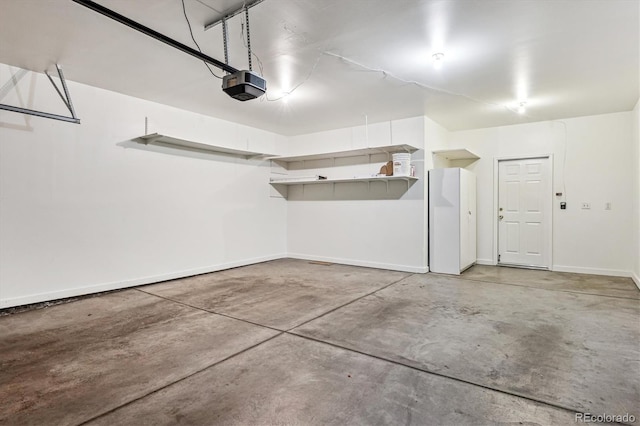 2870 W Riverwalk Cir Unit B, Littleton, CO 80123 - garage featuring a garage door opener and baseboards