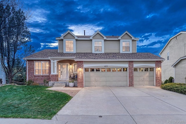 traditional home with brick siding, a shingled roof, a front lawn, and concrete driveway