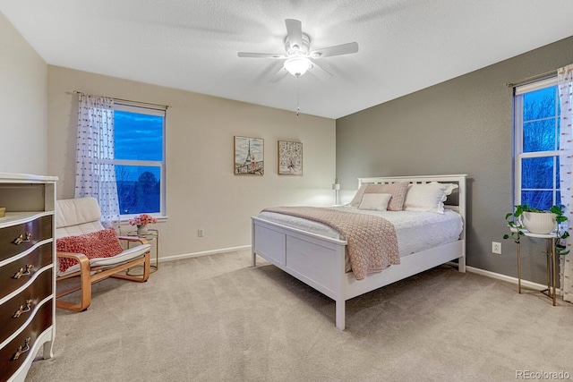 bedroom with carpet floors, baseboards, and a ceiling fan