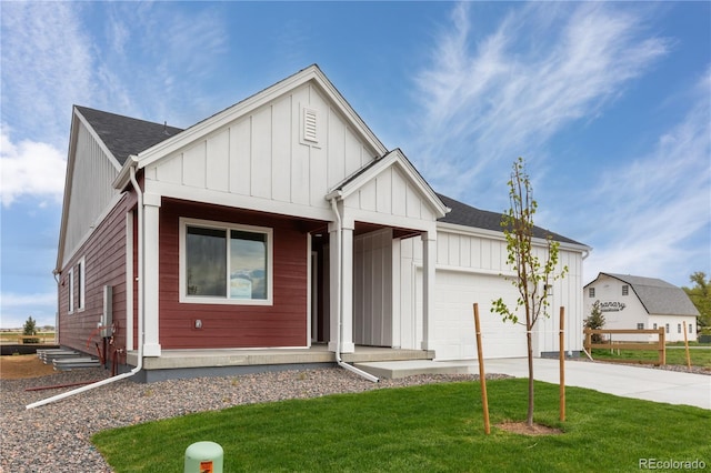 modern farmhouse style home featuring board and batten siding, an attached garage, driveway, and a front lawn