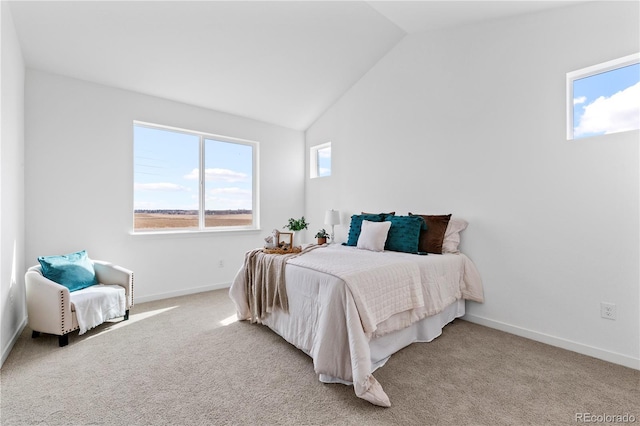 bedroom with vaulted ceiling, light colored carpet, and baseboards