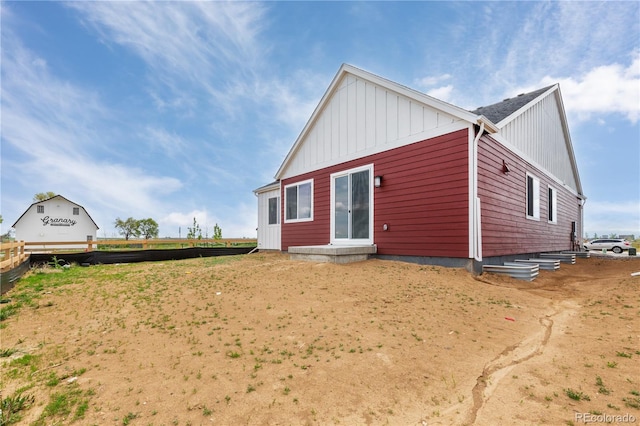 rear view of house with board and batten siding