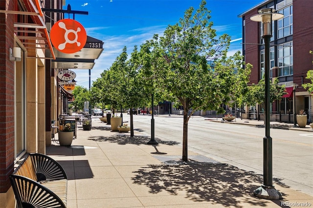 view of street with street lighting, curbs, and sidewalks