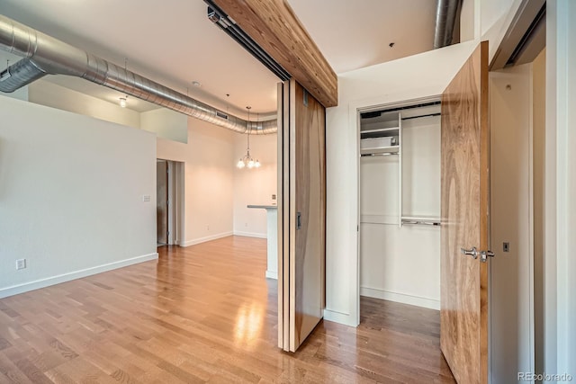 interior space with baseboards and light wood-style flooring