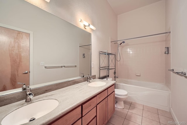 full bathroom featuring double vanity, toilet, tile patterned flooring, and a sink