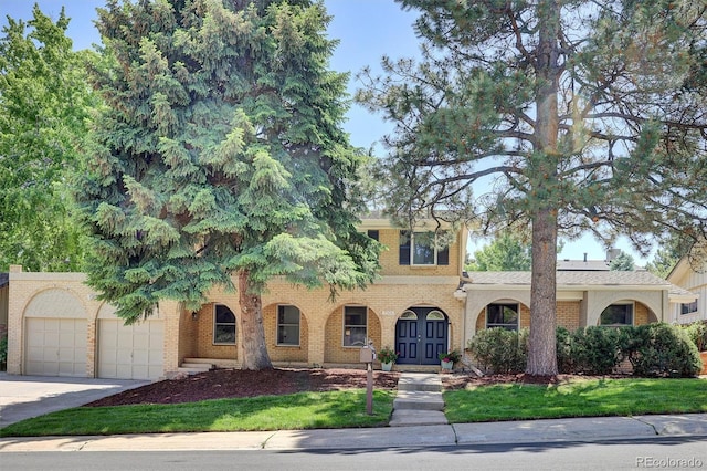 7504 E Jefferson Dr, Denver, CO 80237 - view of front of house with concrete driveway, brick siding, and an attached garage