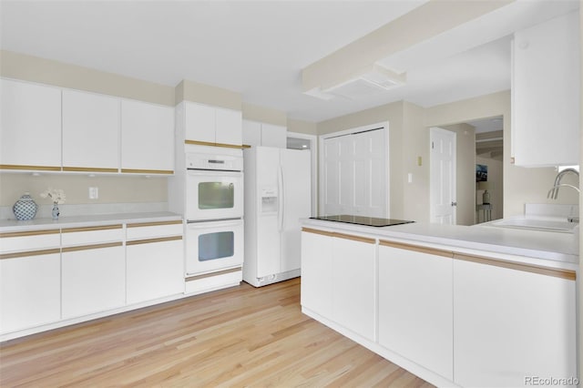 7504 E Jefferson Dr, Denver, CO 80237 - kitchen with white appliances, a sink, white cabinetry, light wood-style flooring, and light countertops