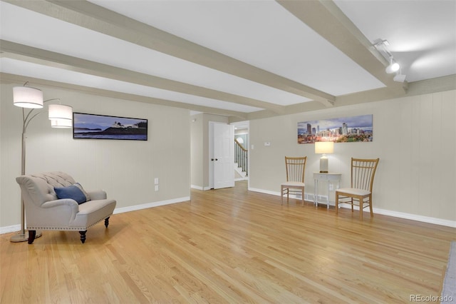 7504 E Jefferson Dr, Denver, CO 80237 - living area featuring wood finished floors, stairway, baseboards, rail lighting, and beamed ceiling