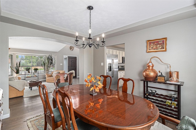 dining area featuring dark hardwood / wood-style floors and a notable chandelier