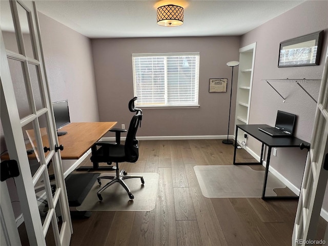 office featuring hardwood / wood-style floors and french doors