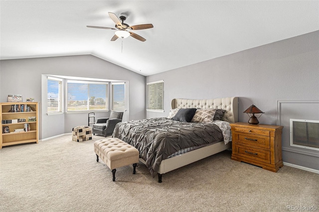 carpeted bedroom with ceiling fan and vaulted ceiling