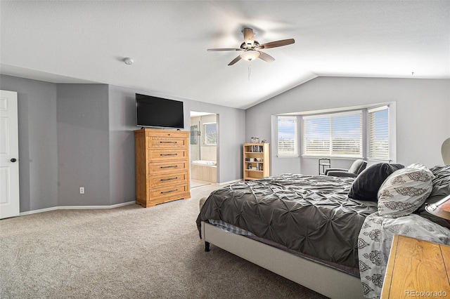 bedroom with ceiling fan, lofted ceiling, connected bathroom, and carpet floors